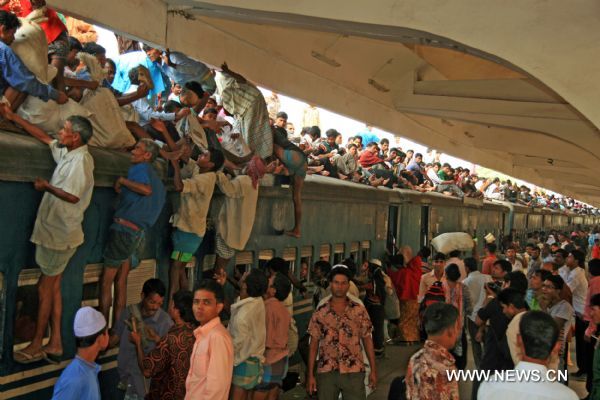 People climb on the rooftop of a homebound train in Dhaka, capital of Bangladesh on Nov. 16, 2010.