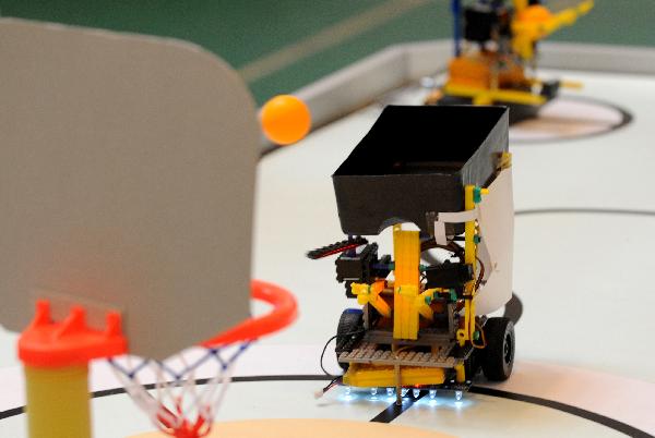 A robot plays basketball during a contest held in Hangzhou, east China's Zhejiang Province, Nov. 18, 2010.