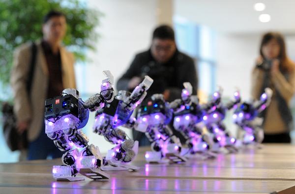 Robots dance during a contest held in Hangzhou, east China's Zhejiang Province, Nov. 18, 2010. 