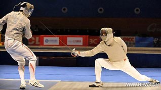 China's Liu Xiao (R) confronts Japan's Kudo Shinya during men's team sabre semifinals match of fencing at the 16th Asian Games in Guanghzou, south China's Guangdong Province, Nov. 22, 2010. China beat Japan 45-19