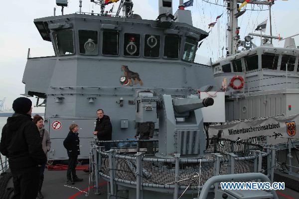 Visitors board the German mine countermeasures vessel called 'Rottweil' at the navy base in Zeebrugge, Belgium, Nov. 21, 2010. 