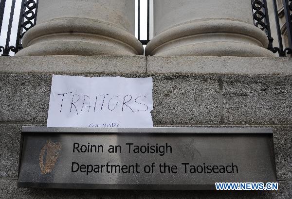 A placard reading &apos;Traitors&apos; is placed at the gate of the Government Buildings, in Dublin, Ireland, Nov. 21, 2010.
