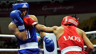 Zou Shiming (L) of China competes with Hatsanai Phoilevy of Laos during the men's boxing 46-49kg match at the 16th Asian Games in Foshan, south China's Guangdong Province, Nov. 22, 2010. Zou Shiming won the match by 13-1.