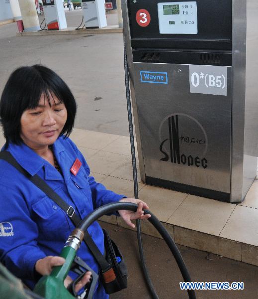 A worker of gas station refuels 'B5' biodiesel for a farm vehicle in Chengmai County, south China's Hainan Province, Nov. 22, 2010. 