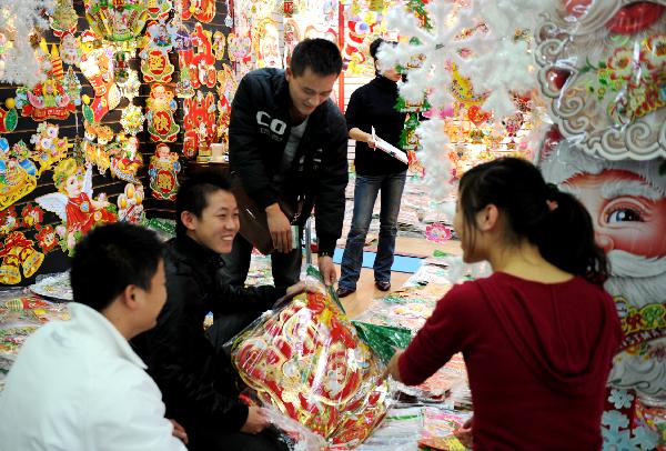 Customers select Christmas ornaments in Yiwu City of east China's Zhejiang Province, on Nov. 23, 2010. 