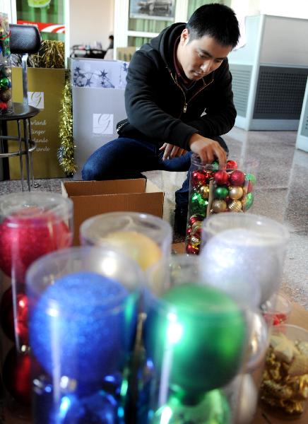 A staff member sorts Christmas ornaments in Yiwu City of east China's Zhejiang Province, on Nov. 22, 2010.