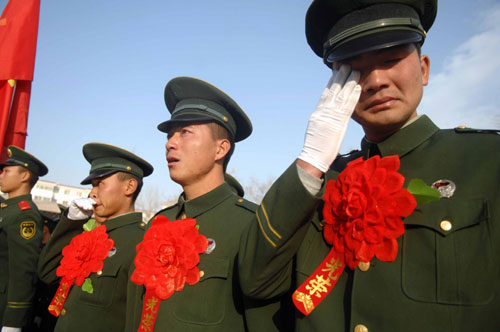 Soon-to-be-retired soldiers sing songs and weep at a farewell ceremony held at Ningxia Paramilitary Police Corps in Yinchuan, Ningxia Hui autonomous region, Nov 23, 2010. [Xinhua] 