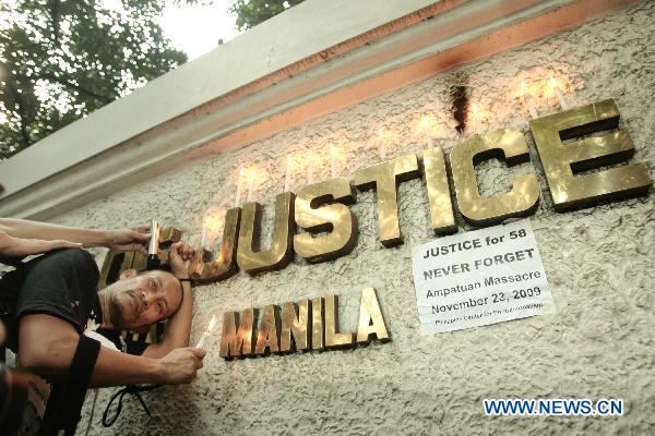 Joe Haresha Tanodra, president of the Press Photographers of the Philippines, has his head shaved in front of the Department of Justice as he and fellow photographers commemorates the first anniversary of the Maguindanao massacre and calls for justice for their fallen comrades and civilians in Manila, the Philippines, Nov. 23, 2010. 