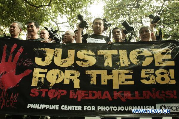 Commemorating the first anniversary of the Maguindanao massacre, photojournalists belonging to Philippine Center for Photojournalism PCP hold a rally in front of the Department of Justice office as they calling for speedy justice for their fallen comrades and civilians in Manila, the Philippines, Nov. 23, 2010. 