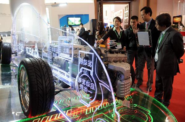 Visitors look at a model of electromobile at China International Green Industry Expo 2010 (CIGIE) in Beijing, Capital of China, on Nov. 24, 2010.