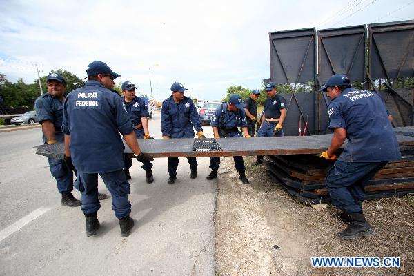 Policemen carry metal barriers at the venue of the upcoming United Nations Climate Change Conference in Cancun, Mexico, on Nov. 24, 2010. 