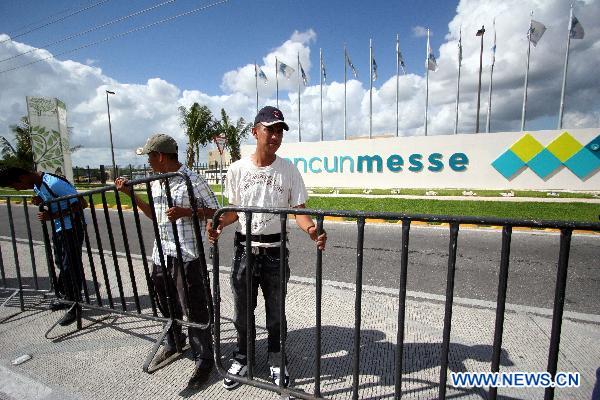 Workers install metal barriers at the venue of the upcoming United Nations Climate Change Conference in Cancun, Mexico, on Nov. 24, 2010. 