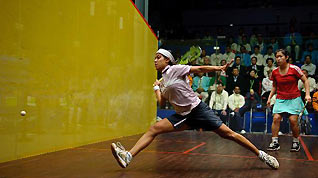 Nicol Ann David(L) of Malaysia hits the ball during the women's team final of Squash against Hong Kong of China at the 16th Asian Games in Guangzhou, south China's Guangdong Province, Nov. 25, 2010.
