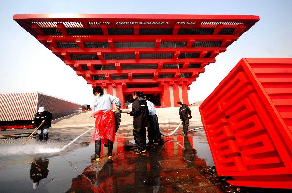 Workers clean the plaza of Shanghai Expo's China Pavilion in Shanghai, east China, Nov. 25, 2010.