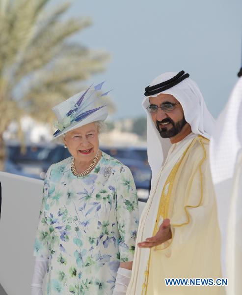 Britain&apos;s Queen Elizabeth II (L) is escorted by Sheikh Mohammed bin Rashed al-Maktoum, vice president and prime minister of the United Arab Emirates (UAE) and ruler of Dubai emirate, in Abu Dhabi on Nov. 25, 2010. 
