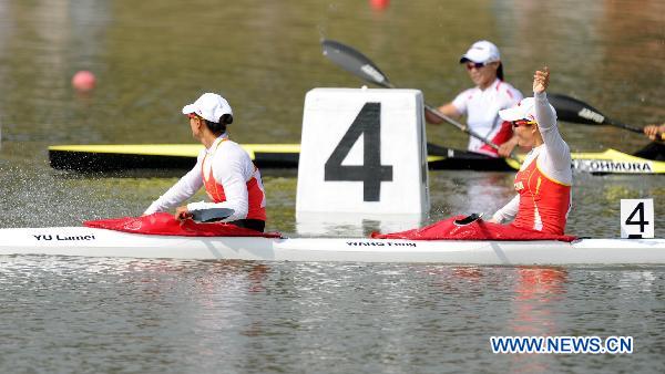China's Wang Feng/Yu Lamei (front) celebrate their victory during the women's kayak double 500 final at the 16th Asian Games in Guangzhou, southeast China's Guangdong Province, Nov. 26, 2010.