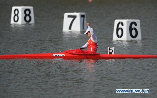 China's Zhou Yu celebrates after she cross the finish line during the women's kayak single 500 final at the 16th Asian Games in Guangzhou, southeast China's Guangdong Province, Nov. 26, 2010.