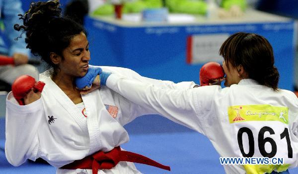 Japan's Miyamoto Yu (R) competes against Malaysia's Yamini Gopalasamy during the women's -61kg final of Karate at the 16th Asian Games in Guangzhou, south China's Guangdong Province, Nov. 26, 2010. 