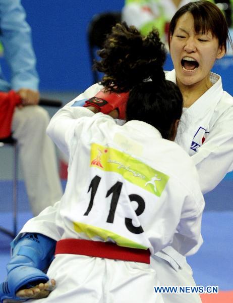 Japan's Miyamoto Yu (back) competes against Malaysia's Yamini Gopalasamy during the women's -61kg final of Karate at the 16th Asian Games in Guangzhou, south China's Guangdong Province, Nov. 26, 2010. 