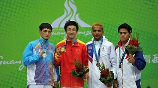 Gold medalist China's Zou Shiming (2nd L), silver medalist Kazakhstan's Birzhan Zhakypov (L) and bronze medalists Thailand's Amnat Ruenroeng(2nd R) and Victorio Iii Saludar of the Philippines pose in the awarding ceremony of men's 46-49kg boxing at the 16th Asian Games in Foshan, south China's Guangdong Province, Nov. 26, 2010.