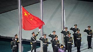 Chinese national flag is raised at the closing ceremony of the 16th Asian Games held at the Haixinsha Island in Guangzhou, south China's Guangdong Province, on Nov. 27, 2010.