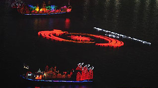 Photo taken on Nov. 27, 2010 shows floats and lights on the Zhujiang River, or the Pearl River, during the closing ceremony of the 16th Asian Games held at the Haixinsha Island in Guangzhou, south China's Guangdong Province.