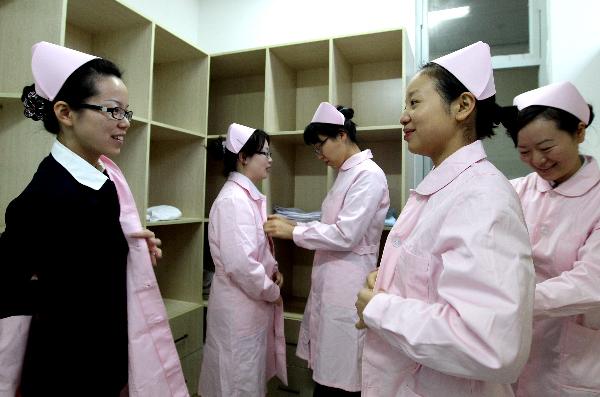 Embalmers get dressed before work in Shanghai, east China, on Nov. 27, 2010. 