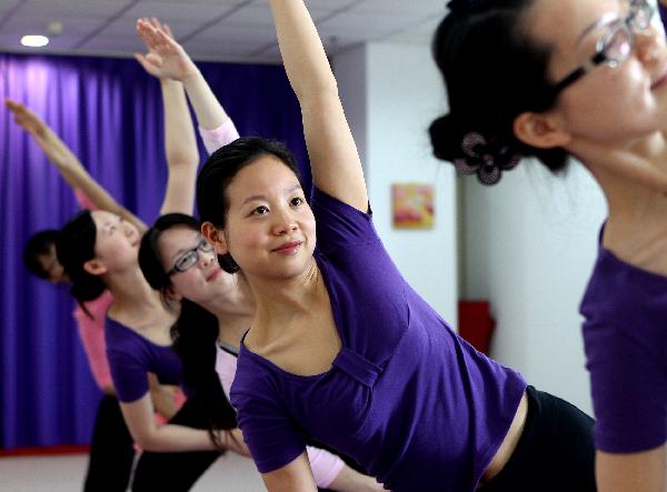 Embalmers practise yoga during their leisure time in Shanghai, east China, on Nov. 27, 2010. 