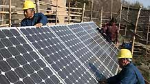 State Grid staffs work with photovotaic battery panels in Neixiang County, central China's Henan Province, Nov 29, 2010.