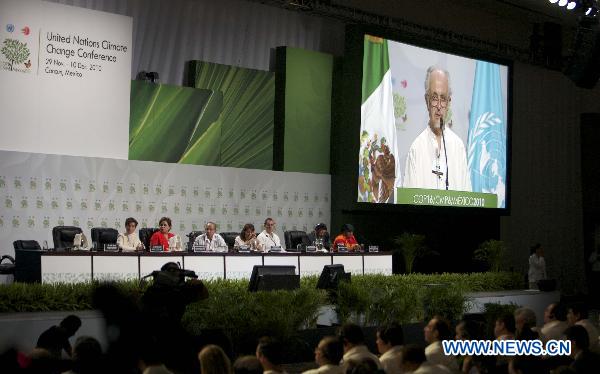 Participants attend the opening session of the United Nations Climate Change Conference (COP-16) in Cancun, Mexico, Nov. 29, 2010. 