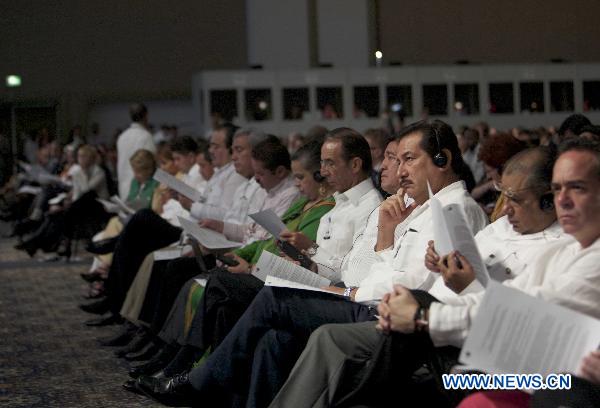 Participants attend the opening session of the United Nations Climate Change Conference (COP-16) in Cancun, Mexico, Nov. 29, 2010. 