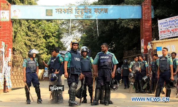 Policemen stand guard as a countrywide general strike is underway in Dhaka, capital of Bangladesh, on Nov. 30, 2010. 