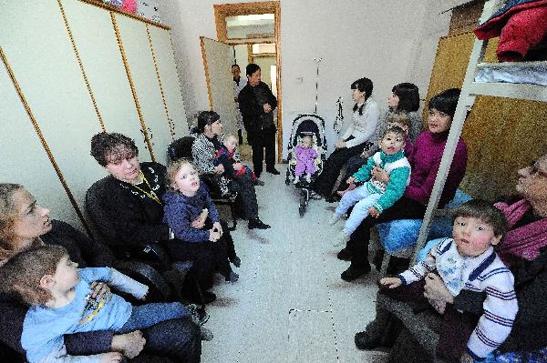 Infant patients and their parents wait for acupuncture treatment to an infant patient in a hospital in Harbin, capital of northeast China's Heilongjiang Province, Nov. 30, 2010. 