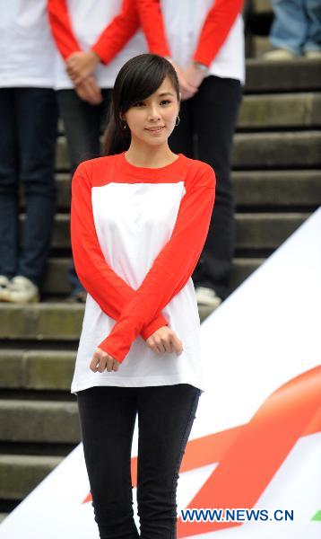 Actress Tammy Chen poses to form the shape of a red ribbon in front of a museum during an activity in Taipei, southeast China's Taiwan, on Nov. 30, 2010, a day ahead of the World AIDS Day. 