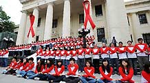 Some 100 'campus ambassadors of AIDS prevention' pose to form the shapes of red ribbons in front of a museum during an activity in Taipei, southeast China's Taiwan, on Nov. 30, 2010, a day ahead of the World AIDS Day.
