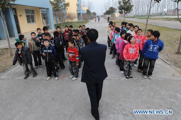 Orphans, whose parents died of AIDS, line up for dinner at the Zhonghua Red Ribbon Home, an orphanage in Shangcai County, central China's Henan Province, Nov. 30, 2010.