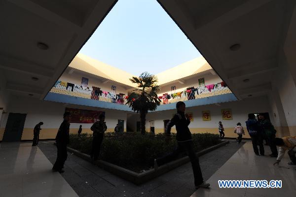 Orphans, whose parents died of AIDS, play a game at the Zhonghua Red Ribbon Home, an orphanage in Shangcai County, central China's Henan Province, Nov. 30, 2010. 