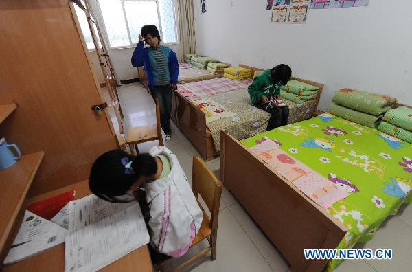 Three girls, whose parents died of AIDS, are seen at the dormitory in the Zhonghua Red Ribbon Home, an orphanage in Shangcai County, central China's Henan Province, Nov. 30, 2010. 