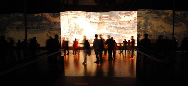 Visitors look at the animated version of the Riverside Scene at the Qingming Festival, at China Pavilion of the World Expo Park in Shanghai, east China, Dec. 1, 2010. 
