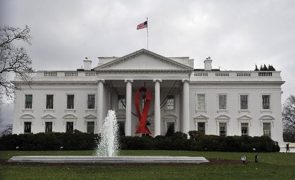 A red AIDS ribbon hangs in front of the White House in recognition of the World AIDS Day, in Washington D.C., capital of the United States, Dec. 1, 2010.