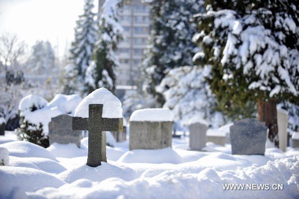 Snow covers the gravestones in Geneva, Switzerland, Dec. 2, 2010. Weather turned fine in Geneva on Thursday after the continuous snowfall. 