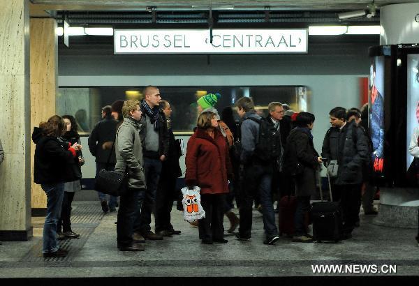 Commuters wait for trains at the Central Station in Brussels, capital of Belgium, Dec. 2, 2010. 