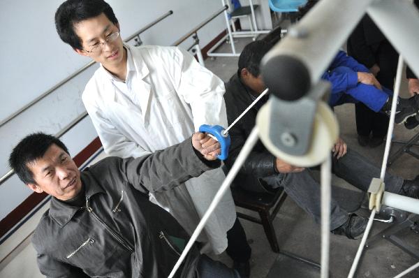 Physically challenged people pracice on rehabilitation equipments in a community rehabilitation center in Binzhou, east China's Shandong Province, Dec. 3, 2010, the 19th International Day of Disabled Persons. 