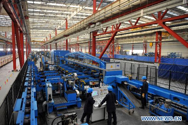 Workers operate at the plant of the Marcegaglia (China) Co., LTD. in Yangzhou, east China's Jiangsu Province, Dec. 3, 2010. 