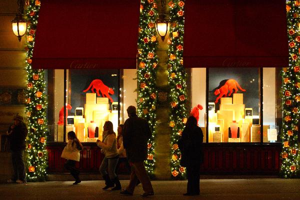 People walk in front of the Christmas window of a store in New York Dec. 4, 2010. The whole city is in the festive mood as Christmas Day draws near. 