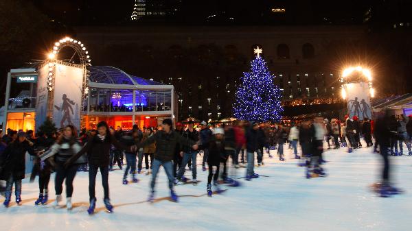People skate in front of the Christmas tree at Byrant Park in New York Dec. 4, 2010. The whole city is in the festive mood as Christmas Day draws near. 