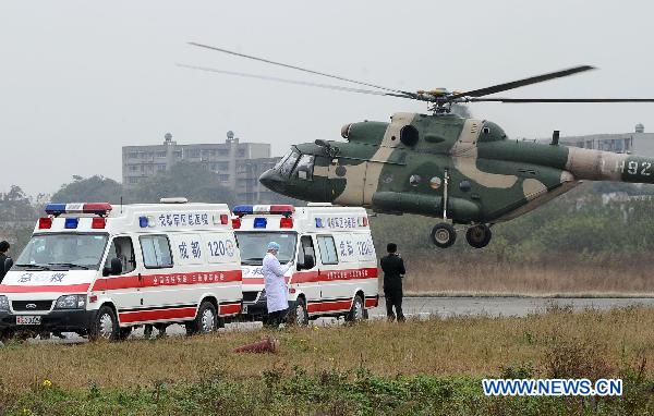 A helicopter carring the injured people landed in an airport in Chengdu, southwest China's Sichuan Province, Dec. 6, 2010. Four injured people in the wild fire in Daofu County have been transfered to the hospitals in Chengdu by helicopters to receive further medical treatment on Monday. [Xinhua]