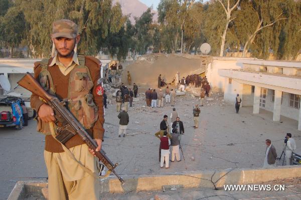 A security member guards at the site of a suicide bombing in northwest Pakistan&apos;s Mohmand region on December 6, 2010. Two suicide bombers Monday targeted a meeting of pro-government tribal elders in a Pakistani tribal region, killing at least 50 people with 120 others injured.