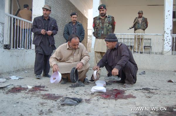 Security personnel check the site of a suicide bombing in northwest Pakistan&apos;s Mohmand region on December 6, 2010. Two suicide bombers Monday targeted a meeting of pro-government tribal elders in a Pakistani tribal region, killing at least 50 people with 120 others injured.