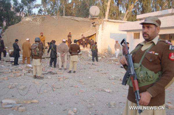 A security member guards at the site of a suicide bombing in northwest Pakistan&apos;s Mohmand region on December 6, 2010. Two suicide bombers Monday targeted a meeting of pro-government tribal elders in a Pakistani tribal region, killing at least 50 people with 120 others injured. 